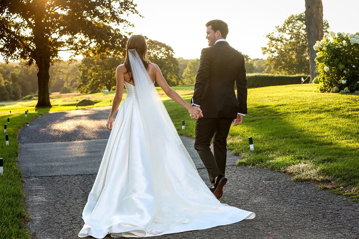 A Beautiful bride and groom image walking away candidly at Westchester Country Club Rye Westchester County New York summer wedding by Peter Oberc Wedding Photography