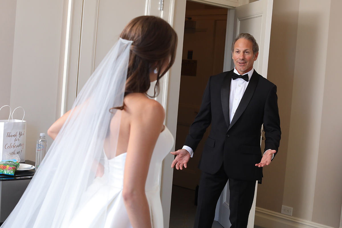 A dad seeing his daughter in her bridal dress for the first time by Peter oberc wedding photography westchester country club rye New York photojournalistic romantic