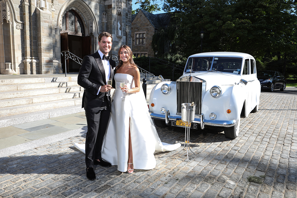 Romantic photo of bride and groom at limo in front of Resurrection Church in Rye Westchester County New York by Peter Oberc Wedding Photography