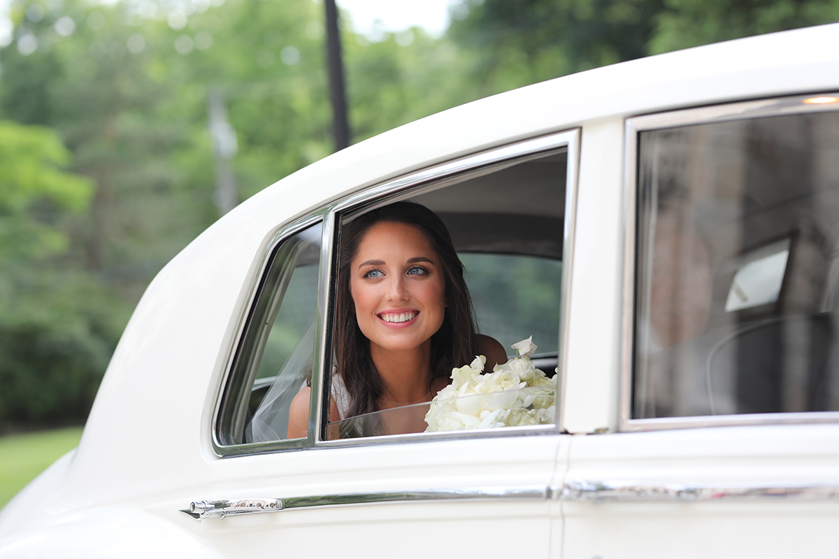 An awesome candid wedding photography photo of a bride in limo Rye, NY Westchester County