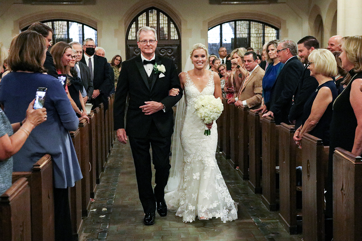 A photojournalistic candid image of a bride and dad walking down the aisle of Resurrection Church in Rye New York Westchester County by Peter Oberc Wedding Photography