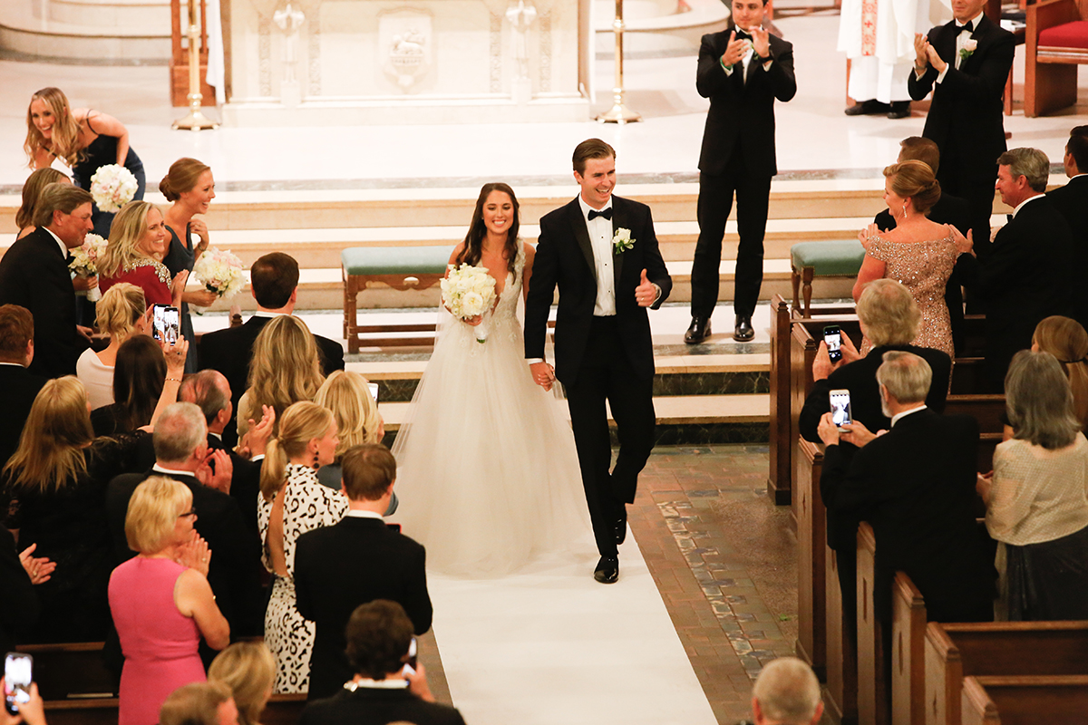 A photojournalistic candid image of a bride and groom walking down the aisle of Resurrection Church in Rye New York Westchester County by Peter Oberc Wedding Photography