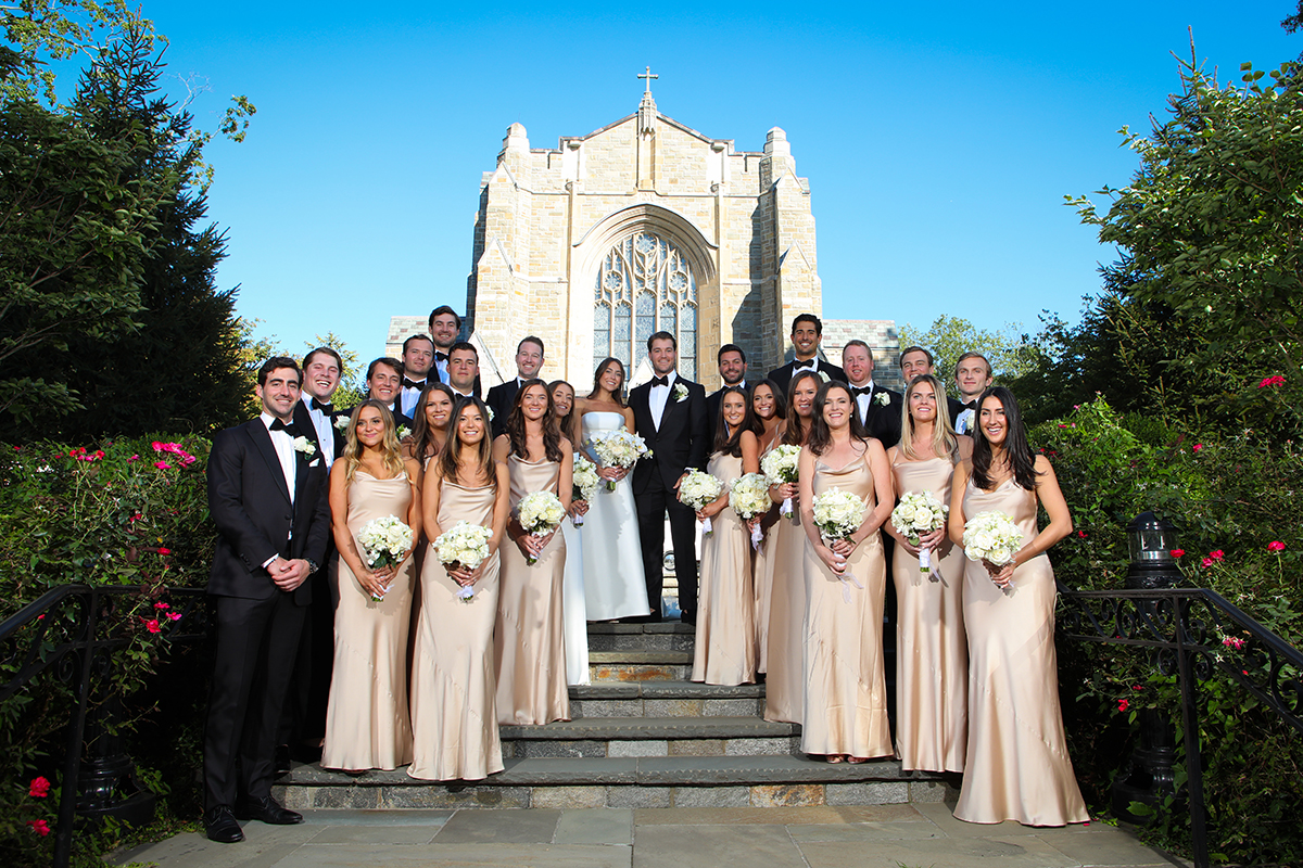 A classic wedding photography group shot of the bridal party at Resurrection Church in Rye New York Westchester County by Peter Oberc Wedding Photography