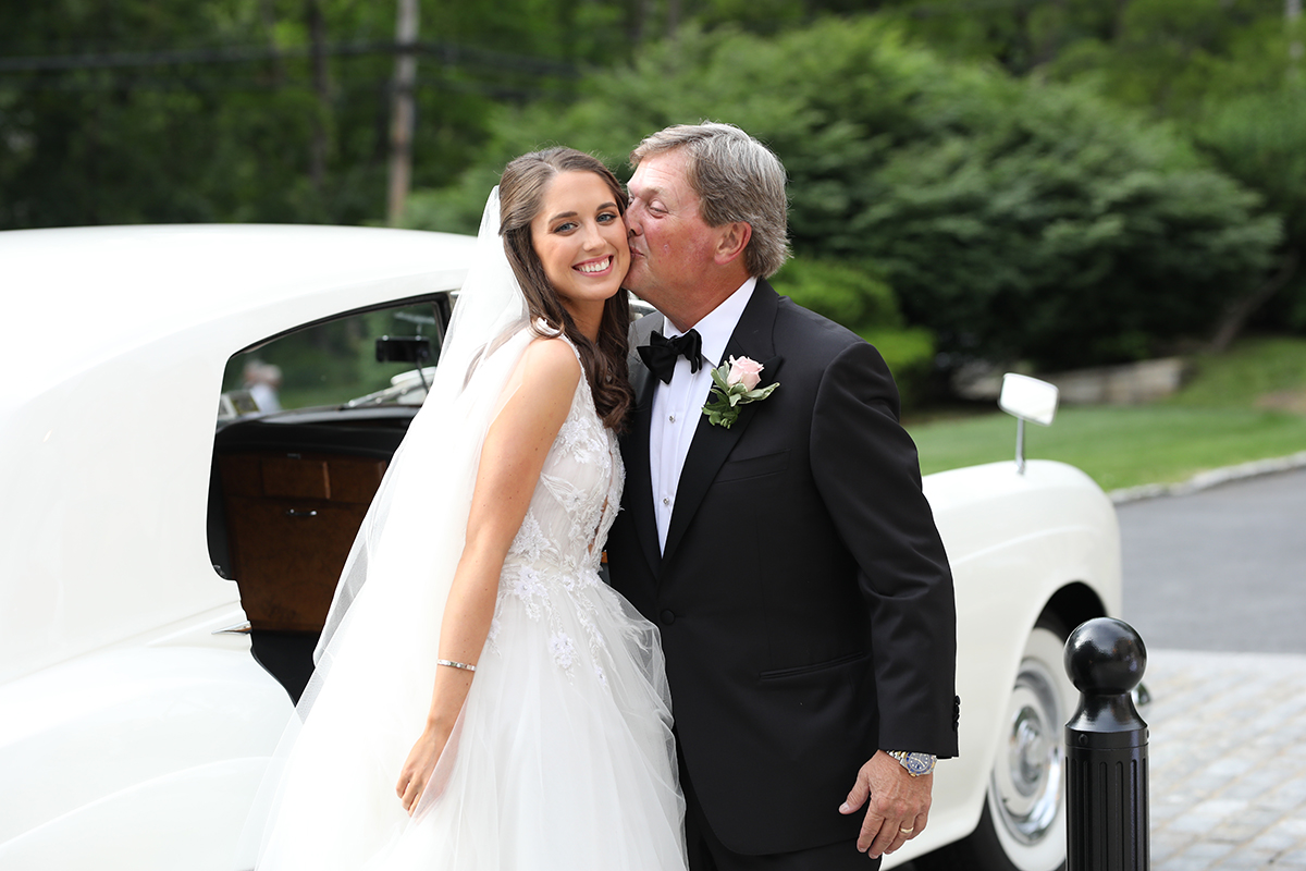 Peter oberc wedding photography candid of bride coming out of limo at Resurrection Church in Rye, NY Westchester county dad kiss candid photos